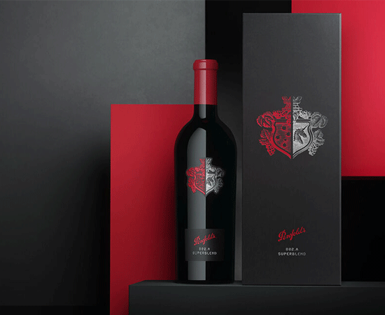 Superblend bottle sits next to box against a geometric black and red background. 