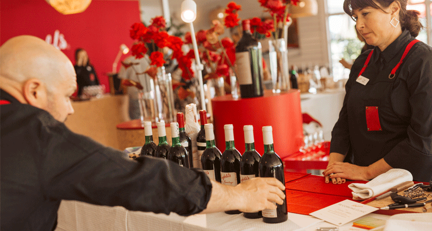 Winemaker, Matt Woo assesses the ullage height of a lineup of Grange bottles. 